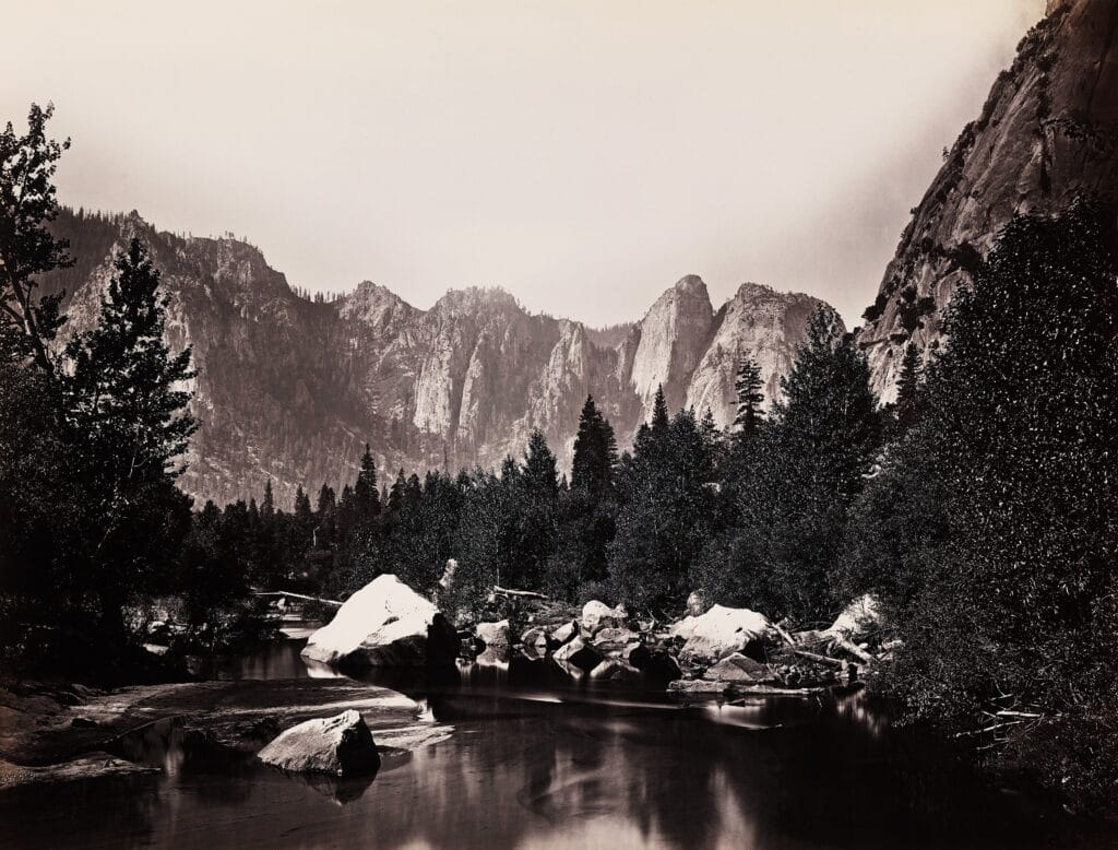 Nineteenth-century photograph of the Merced River winding through Yosemite Valley beneath granite cliffs